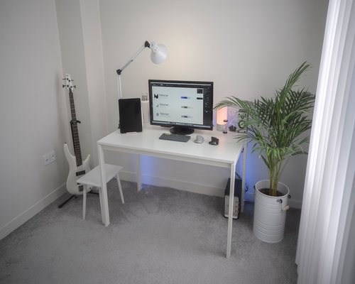 Ergonomic layout of a clean office desk with soft indirect ambient light sources